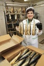 Fish factory worker with smoked fish. Fish industry Royalty Free Stock Photo