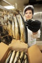 Fish factory worker with smoked fish. Fish industry Royalty Free Stock Photo