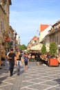 September 11 2021 - Brasov, Kronstadt in Romania, Transylvania: Tourists on the ancient street of the medieval city Royalty Free Stock Photo