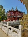 Tea pavilion in traditional red color with blue roof beams in the Chinese garden in the wildlife park Pairi Daiza