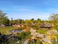 September 2018 - Brugelette, Belgium: view of a traditional African landscape with straw huts in the steppe at the zoo Pairi Daiza