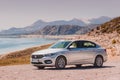 Fiat Egea on a dirt road or gravel surface against the background of a classic Mediterranean