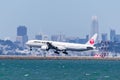 September 1, 2019 Burlingame / CA / USA - Japan Airlines aircraft landing at San Francisco International Airport; Downtown San