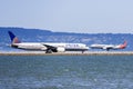 September 1, 2019 Burlingame / CA / USA - United Airlines aircraft preparing to take off and American Airlines aircraft landing at