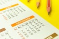 September calendar close-up, back to school concept background with pencils on a yellow table background Royalty Free Stock Photo