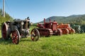 Three tractors plowing a field