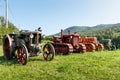 Three tractors plowing a field