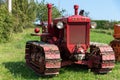 Three tractors plowing a field