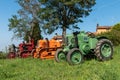 Three tractors plowing a field