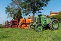 Three tractors plowing a field