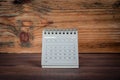 SEPTEMBER 2024 cardboard desk calendar on a wooden texture background