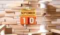 September 10 - Daily colorful Calendar with Block Notes and Pencil on wood table background