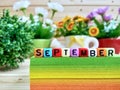 September. Colorful cube letters on sticky note block.