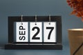 September 27, Date design with a black wooden calendar for a business.