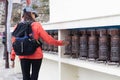 Female tourist rolling buddhism prayer bell in Namche bazaar village on the way to Everest base camp Trekking in