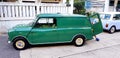 September 29, 2018: Green and Blue/white classic Mini cooper van parked on the street and in front of house Royalty Free Stock Photo