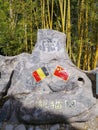 Large rock with the Chinese and Belgian flags at the entrance of the giant panda complex in Pairi Daiza