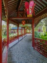 Traditional Chinese wooden corridor in vibrant red with lanterns in the Chinese garden in Pairi Daiza