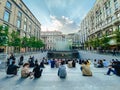 September 25, 2019 Italy. Milan. A lot of people are sitting on steps near apple store in Milan. On staircase, admiring