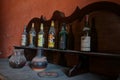 Old bottles of wine and spirits abandoned on a piece of furniture in an abandoned house. Urbex