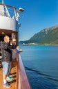 September 14, 2018 - Juneau, AK: Ship passenger with binoculars viewing scenery.