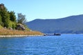 September 13 2023 - Lake Prespa, Albania: Tourists enjoy a boat trip with albanian fishermen