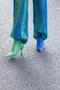 Model wears a pair of blue and green leather boots