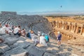 The guide tells a group of tourists about ancient Greek drama and tragedy and mythology in