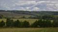 September panorama of collective farm fields and copses. Autumn bad weather in the foothills of the Western Urals.