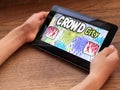 September 2019 Parma, Italy: Kid holding in hands tablet on screen of which crowd city game app downloaded close-up. Crowd city g