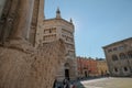 September 2020 Parma, Italy: Piazza Duomo/ Duomo Square view across colorful buildings and statue of wolves.