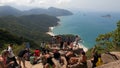 Tourists of different nationalities taking a photo.