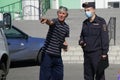 September 02, 2020, Russia, Magnitogorsk. A man on a city street prompts and shows the policeman where the bully has disappeared.