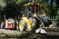 September 8, 2020, Russia, Magnitogorsk. Two backhoe loaders of different sizes are working in one of the city courtyards.