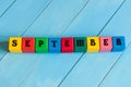 September sign on color wooden cubes with light Royalty Free Stock Photo