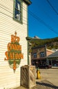 September 15, 2018 - Skagway, AK: Side view of The Red Onion Saloon and public cigarette disposal bin from 2nd Ave. Royalty Free Stock Photo