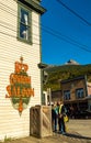 September 15, 2018 - Skagway, AK: Side view of The Red Onion Saloon and public cigarette disposal bin from 2nd Ave. Royalty Free Stock Photo