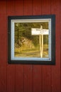 September 15, 2018 - Skagway, AK: Skagway Junction signpost reflected in window on White Pass and Yukon Route rail line.