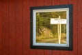 September 15, 2018 - Skagway, AK: Skagway Junction signpost reflected in window on White Pass and Yukon Route rail line.