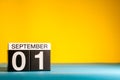 September 1st. Day 1 of month, Back to school concept. Calendar on teacher workplace yellow background. Autumn time