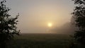 September sunrise over the meadow, autumn morning, sun and fog Royalty Free Stock Photo