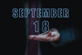september 18th. Day 18 of month, announcement of date of business meeting or event. businessman holds the name of the month and
