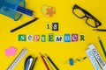 September 18th. Day 18 of month, Back to school concept. Calendar on teacher or student workplace background with school
