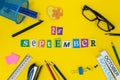 September 25th. Day 25 of month, Back to school concept. Calendar on teacher or student workplace background with school