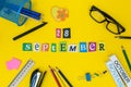 September 28th. Day 28 of month, Back to school concept. Calendar on teacher or student workplace background with school