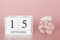 September 15th. Day 15 of month. Calendar cube on modern pink background, concept of bussines and an importent event