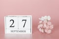 September 27th. Day 27 of month. Calendar cube on modern pink background, concept of bussines and an importent event Royalty Free Stock Photo