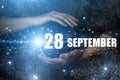 September 28th. Day 28 of month, Calendar date. Human holding in hands earth globe planet with calendar day. Elements of this