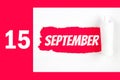 September 15th. Day 15 of month, Calendar date. Red Hole in the white paper with torn sides with calendar date. Autumn month, day