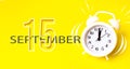 September 15th. Day 15 of month, Calendar date. White alarm clock with calendar day on yellow background. Minimalistic concept of